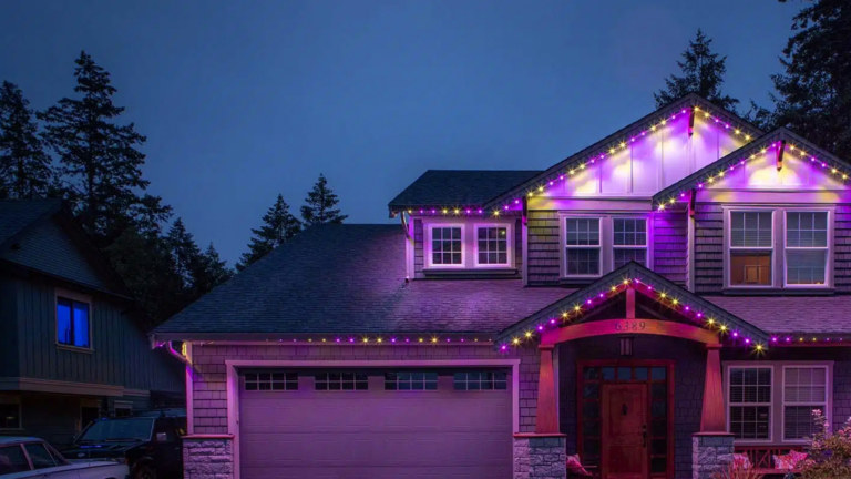 A house lit up for Easter with Gemstone Lights in yellow and purple tones