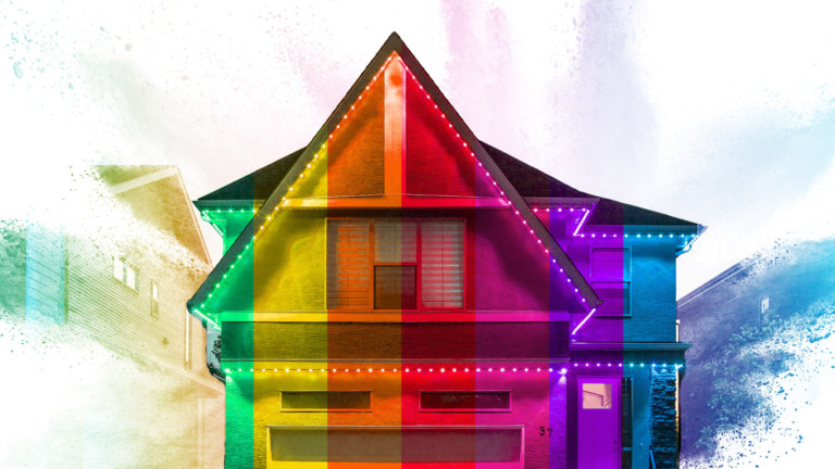 A house featuring smart outdoor LED lights overlaid with rainbow segments.